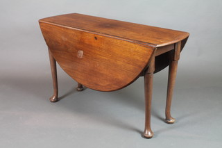 A 19th Century oval drop flap dining table raised on 4 club supports 28"h x 47"w x 15" when closed x 49 1/2" when extended 