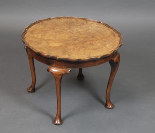 A 1930's circular Queen Anne style figured walnut occasional table with pie crust edge, raised on cabriole supports 17" x 23" diam. 