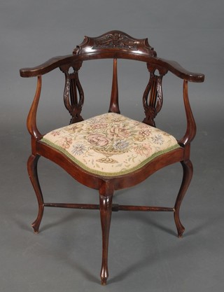 An Edwardian carved walnut corner chair with lyre splat back and upholstered seat, on cabriole supports united by an X framed stretcher 