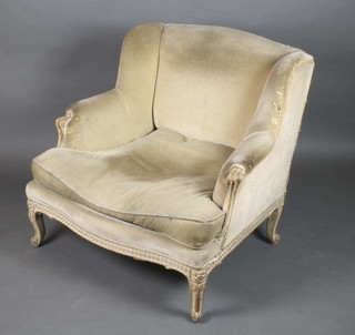 A French style show frame armchair upholstered in yellow material, raised on cabriole supports 