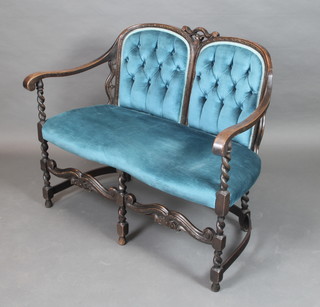 An oak show frame Carolean style double chair back settee, upholstered in blue material with wavy stretcher, raised on spiral turned and block supports 36"h x 43"w x 22"d 