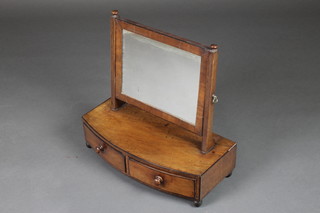 A Georgian mahogany rectangular plate dressing table mirror contained in a mahogany swing frame, the base fitted 2 drawers, raised on bun feet 18"h x 19"w x 9"d 