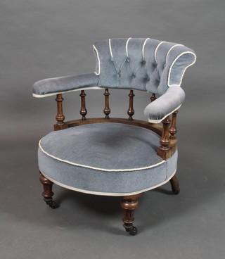 A Victorian walnut tub back chair upholstered in blue buttoned dralon with bobbin turned decoration, raised on turned feet 