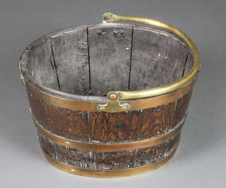 An oval coopered oak coal bucket with brass swing handle 10"h x 16"w x 13"d 