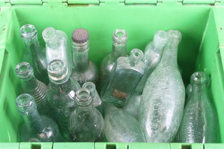 A collection of green glass torpedo bottles and other bottles