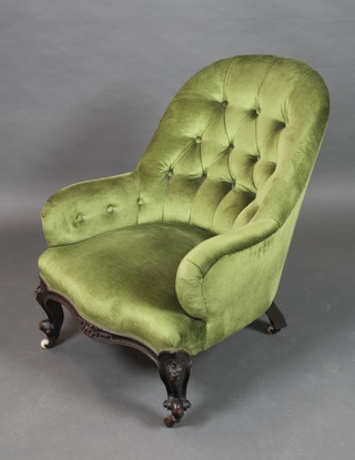 A Victorian tub back chair upholstered in green buttoned Dralon, raised on cabriole supports 