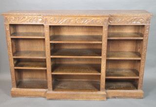 A Victorian carved oak breakfront bookcase, the interior fitted adjustable shelves 46"h x 72"w x 15"d 