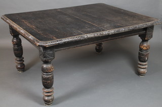 A Victorian carved ebonised extending dining table raised on turned supports 29"h x 59"l x 46"w