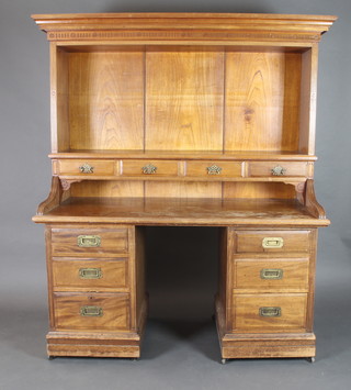 A  Victorian Colonial walnut desk bookcase, the upper section with moulded cornice above bookcase, the base fitted 4 long drawers, the pedestals each fitted 3 long drawers with brass countersunk handles 67"h x 62"w x 26"d  