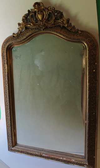A 19th Century Continental arched plate mirror contained in a decorative gilt frame 60"h x 36"w 