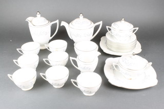 A Minton Pandora pattern tea service comprising teapot, coffee pot, cream jug, 2 lidded bowls, a slow bowl, 7 tea cups, 13 saucers, 10 small plates, 2 cake plates