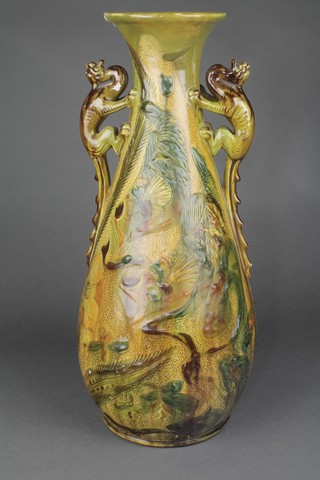 A Brannam Barum Art Nouveau oviform vase with stylised dragon handles decorated with flowers and leaves 20" 