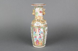 A 19th Century Cantonese famille rose oviform vase with lion handles and panels of figures, pavilion landscapes and panels of birds 10" 