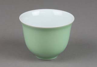 A Japanese green glazed teabowl of plain form with character mark to base 2 1/2" 