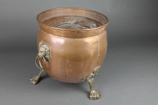 A circular copper coal bin with brass paw supports 12" 