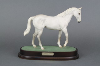 A Royal Doulton figure - Desert Orchid, raised on a wooden socle 10" 