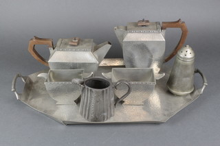 An Art Nouveau Craftsmans pewter 4 piece tea service with octagonal twin handled tea tray 18", teapot, hot water jug, milk jug and sugar bowl, do. planished pewter sugar sifter and a Victorian Britannia metal cream jug  