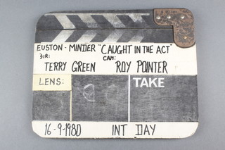 A wooden clapper board used on the Minder series, marked Euston-Minder "Caught In The Act" DIR Terry Green, CAM Roy Pointer, 16/9/1980 INT Day 