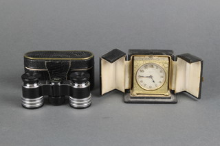 A pair of Beck Kassel Rubin 3x opera glasses and a Zenith travelling alarm clock in a gilt case 