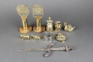 A pair of Austrian pierced brass plaques marked Wien and Tiro, raised on wooden bases 5", a "Polish" paper knife with 5" blade, an Art Nouveau embossed pewter napkin ring, a miniature brass jug, hand bell, brass door knocker decorated 2 wise monkeys, miniature brass figure of a swan and 2 other brass figures   