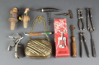 An embossed brass bag 4", 2 Acme Thunderer whistles, a Metropolitan pattern whistle, various corkscrew etc 