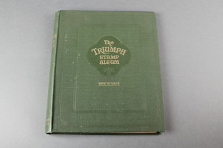 A Triumph green stamp album of World stamps