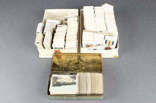 A Players Navy Cut tin containing a collection of cigarette cards together with 2 shallow trays of loose cigarette cards 