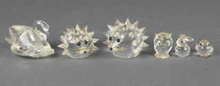 A Swarovski crystal swan 2 1/4", 2 ditto hedgehogs 1 3/4", 1 1/4", an owl 1", a rabbit 1" and a chick 1" 
