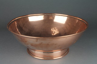 A circular copper bowl raised on a spreading foot 14" 