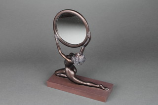 An Art Deco style circular plate wall table mirror supported by a figure of a bronzed naked lady 11"h