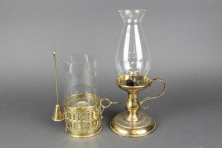 A 19th Century pierced brass chamberstick with clear glass chimney and snuffer together with a later brass chamberstick 