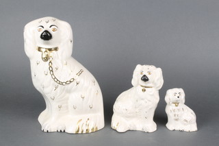 A Beswick Staffordshire style Spaniel 4", 2 Royal Doulton ditto 5" and 9" 