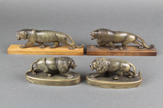 A pair of carved horn figures of walking lions raised on oval bases 5" and a pair of carved horn figures of walking tigers 7" 