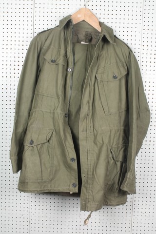 A Nato green combat jacket and trousers 
