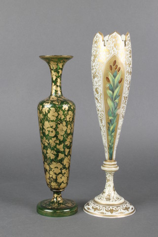 A Victorian Bohemian glass tapered vase, the cream and gilt ground with panels of flowers 12 1/2", a green glass gilt decorated ditto 11" 