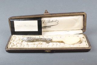A 19th Century cased repousse silver and ivory spoon