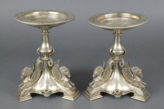 A pair of Victorian silver plated stands with Pegasus supports and triform base with shell decoration 7" 