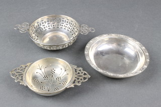 A circular silver bowl in the Arts & Crafts style, Birmingham 1922, 2 silver strainers, 126 grams