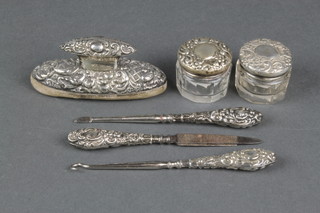 A repousse silver 4 part manicure set, 2 silver mounted bottles