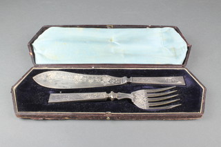 A cased pair of aesthetic style fish servers with formal decoration 