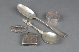 An early Georgian silver table spoon, napkin ring, vesta, apostle style spoon and  a plates spirit label, 122 grams