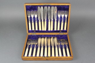 A set of Edwardian silver plated fish eaters for 12 contained in an oak canteen