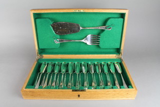 An Art Deco oak canteen containing a set of fish eaters for 12 
