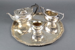 A silver plated 3 piece tea set with gadroon rim and matching circular tray 