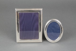 2 modern silver photograph frames, an oval 2" x 2 1/2" and rectangular 6" x 4" 