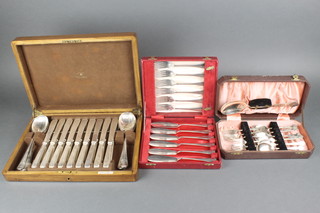 A Mappin & Webb walnut canteen containing a set of silver plated cutlery for 9 and 2 other cased plated sets
