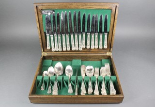 An oak canteen containing a quantity of Kings pattern silver plated cutlery 