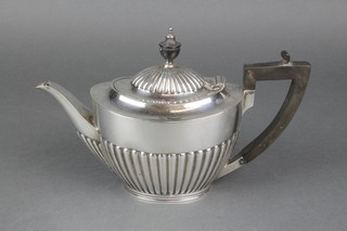 A silver demi-fluted teapot with ebony mounts Sheffield 1919, gross 440 grams