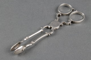A pair of Georgian silver scissor, sugar nips of plain form