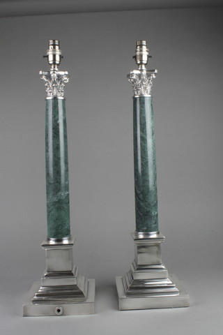 A pair of  silver plated mounted Corinthian column table lamps with marble stems